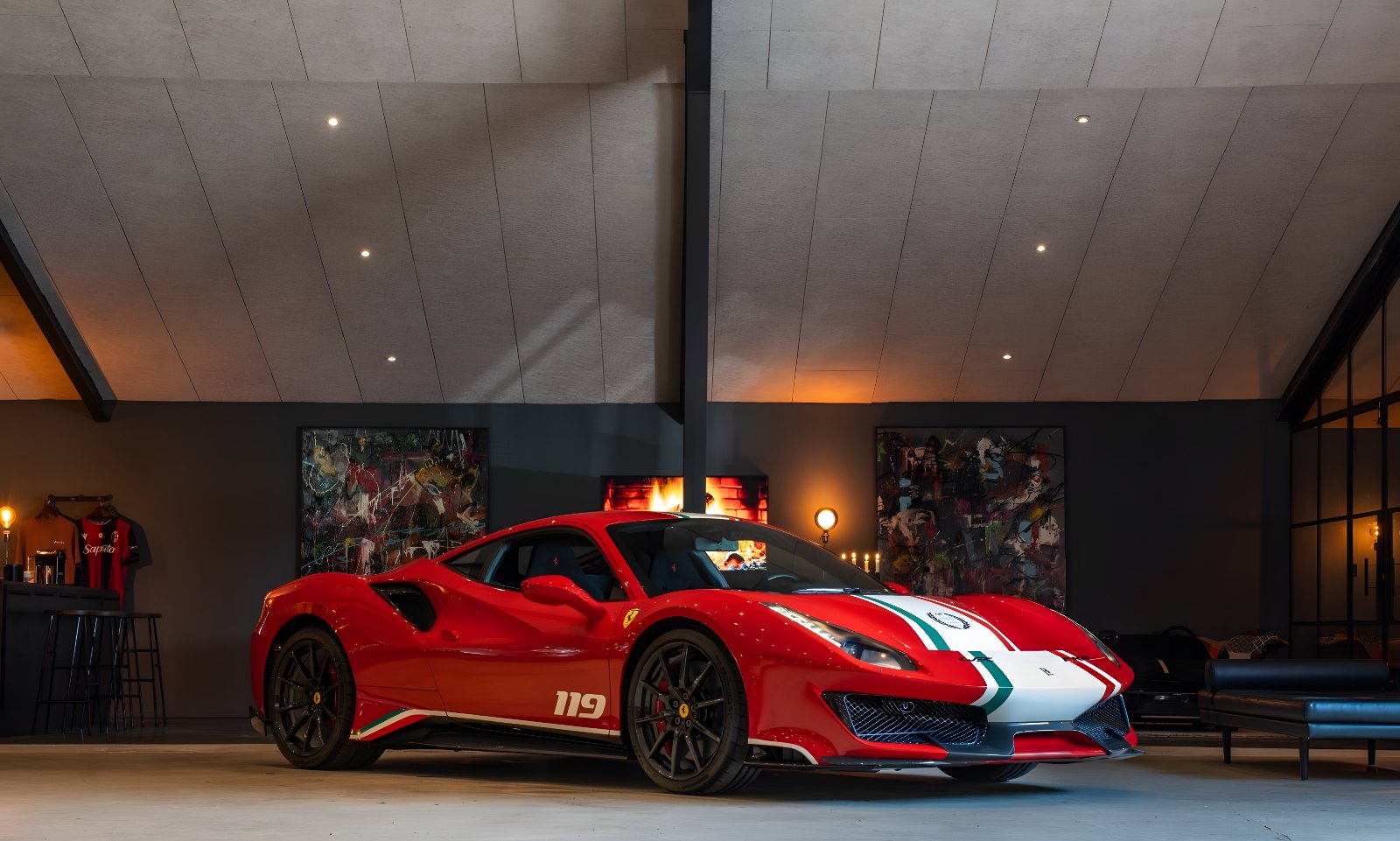 Red Ferrari 488 Pista with white racing stripes in a dark showroom